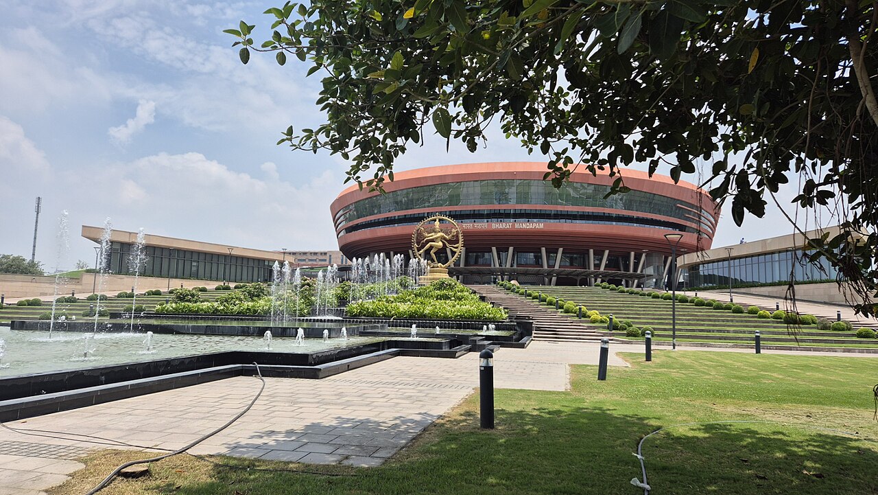 Bharat Mandapam convention centre in New Delhi, with fountains and the Nataraja statue in front.
